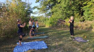 Solawi-Mitglieder beim Yoga am Waldrand